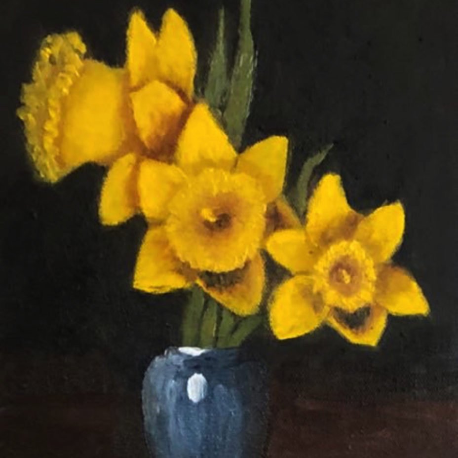 Three daffodils in Blue glass