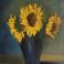 Threr yellow sunflowers in a blue vase